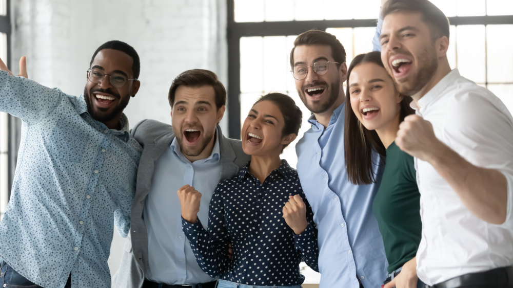 A group of people celebrating in an office.