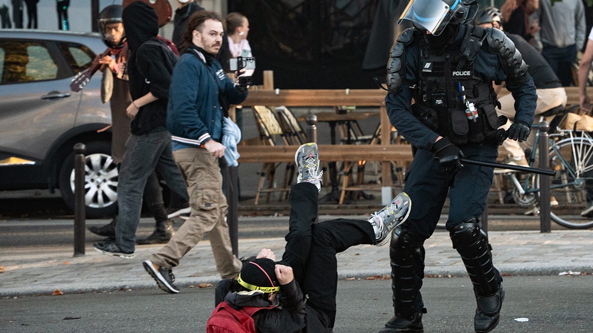 Police officer clashes with protester in Paris