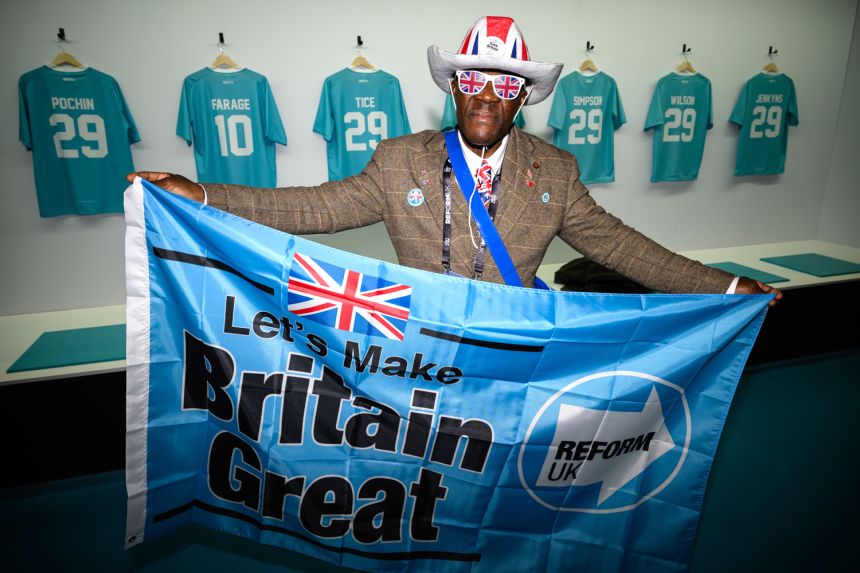 A Reform UK supporter, clad in Union Jack memorabilia, unveils a 