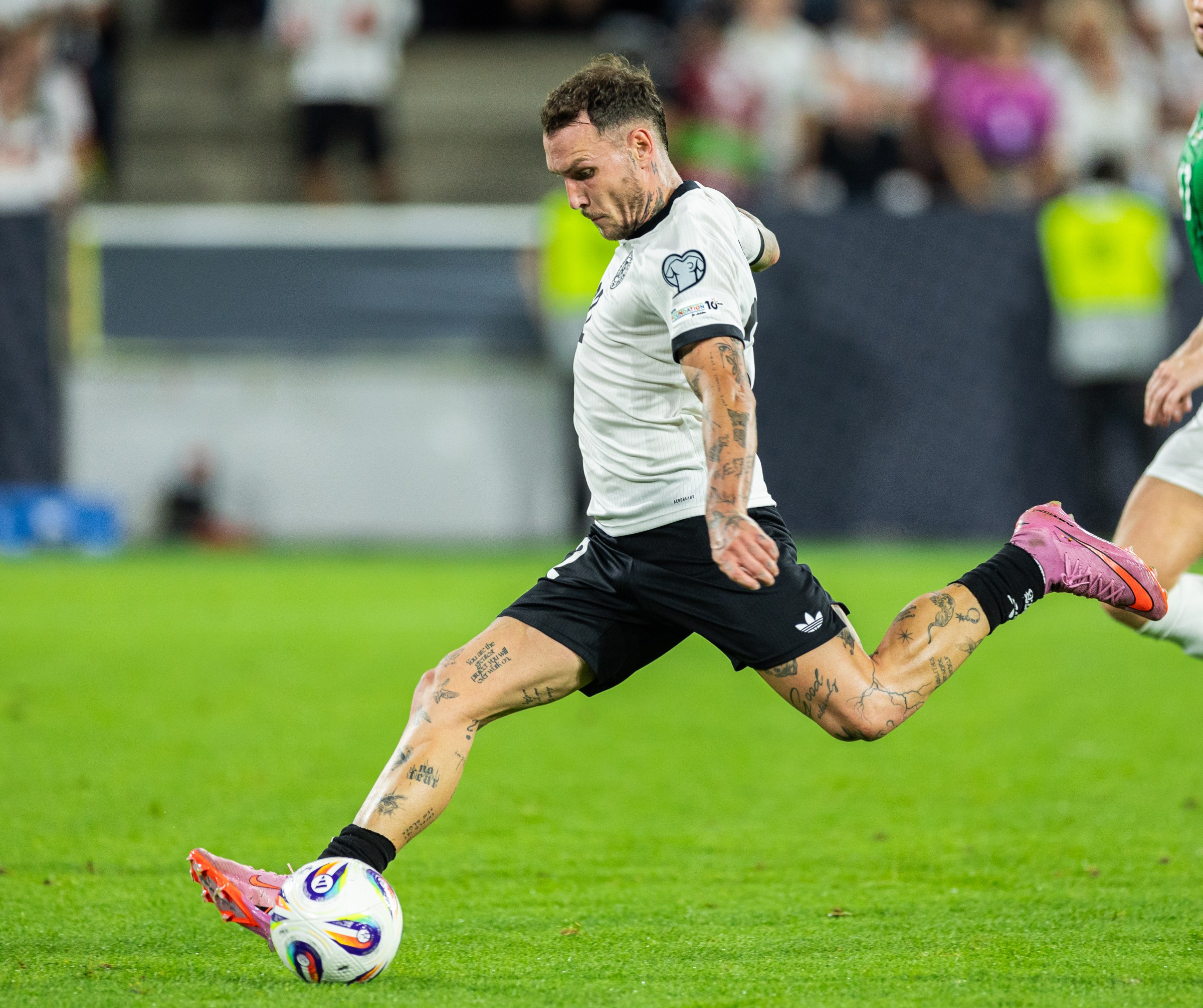 COLOGNE, GERMANY - SEPTEMBER 07: David Raum of Germany takes a shot during the FIFA World Cup 2026 qualifier match between Germany and Northern Ireland at RheinEnergieStadion on September 07, 2025 in Cologne, Germany. (Photo by Boris Streubel/Getty Images)