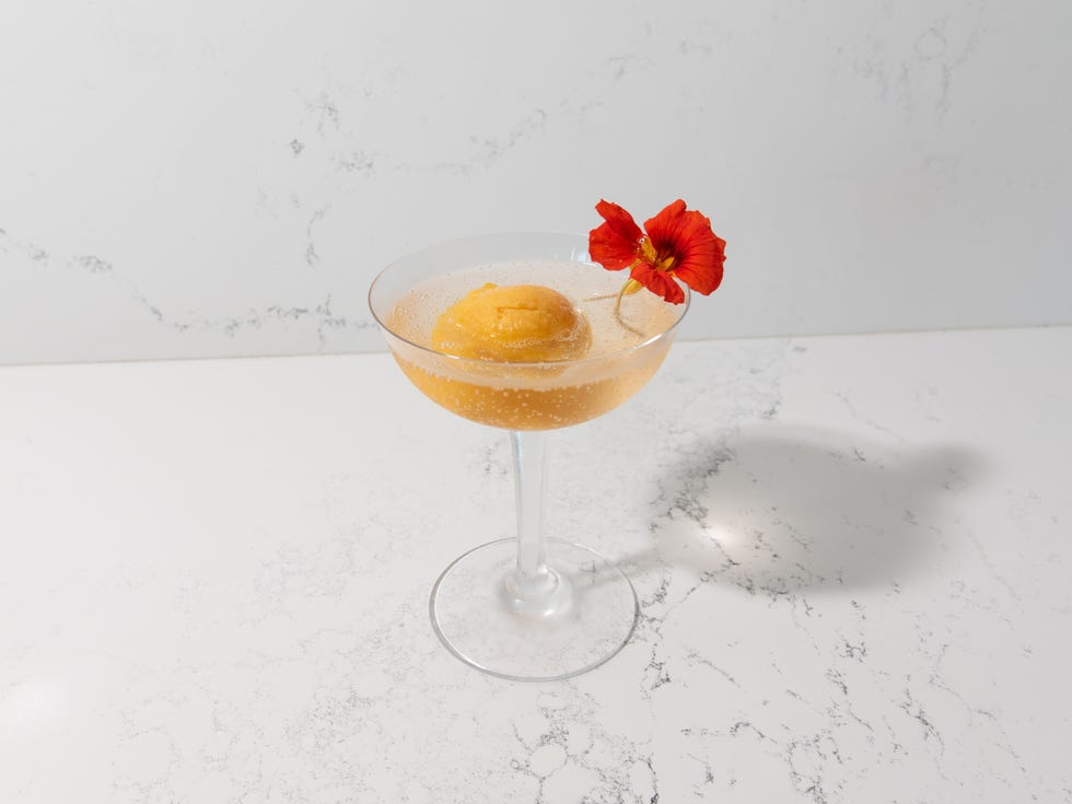 meghan markle champagne float meghan markle champagne float passion fruit sorbet and sparkling wine in a couple garnished with a red nasturtium