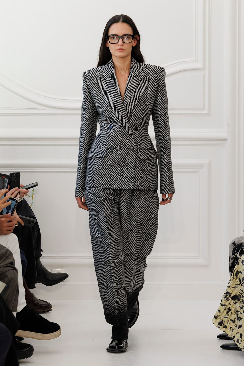 a model showcasing a stylish houndstooth suit on a runway