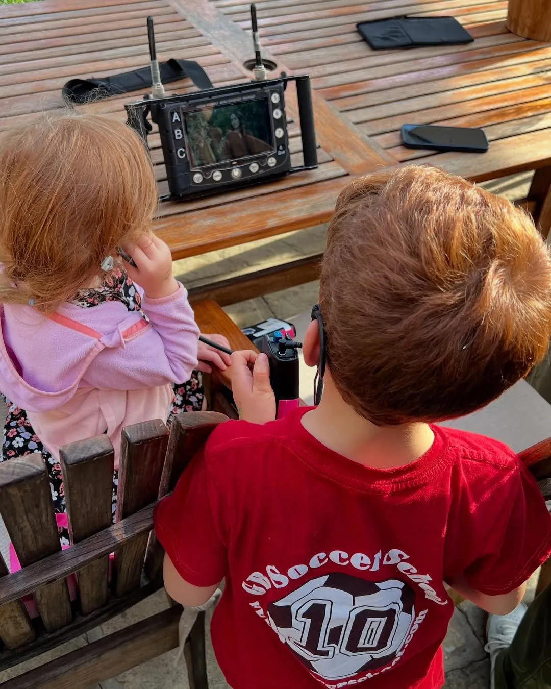 prince harry and meghan's children archie and lilibet watch meghan on a director's screen as she film's her show with love, meghan