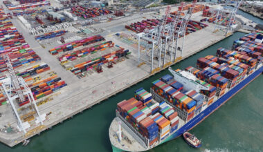 Aerial view of shipping container ship with a full load of colourful containers, Southampton, UK Container Ship Docking