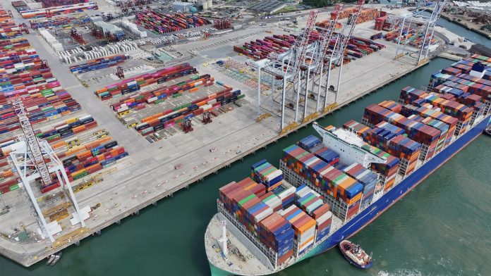 Aerial view of shipping container ship with a full load of colourful containers, Southampton, UK Container Ship Docking
