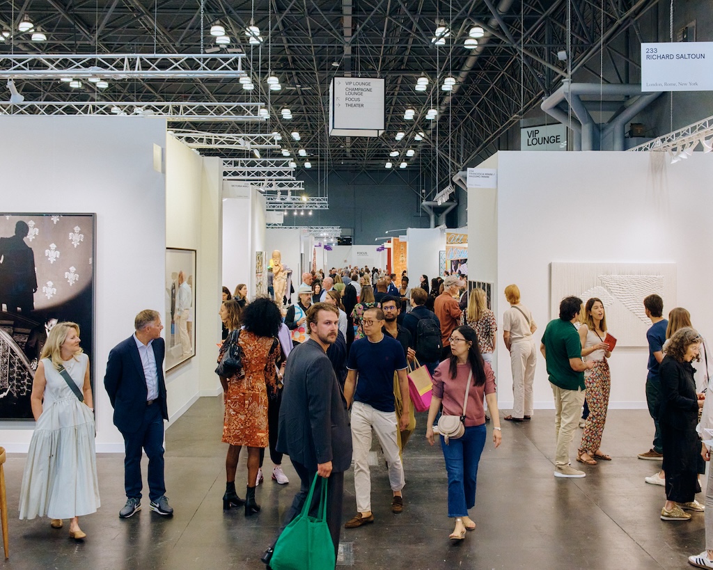 Attendees of the Armory Show's preview day shuffle around the booths in the Javits Center.