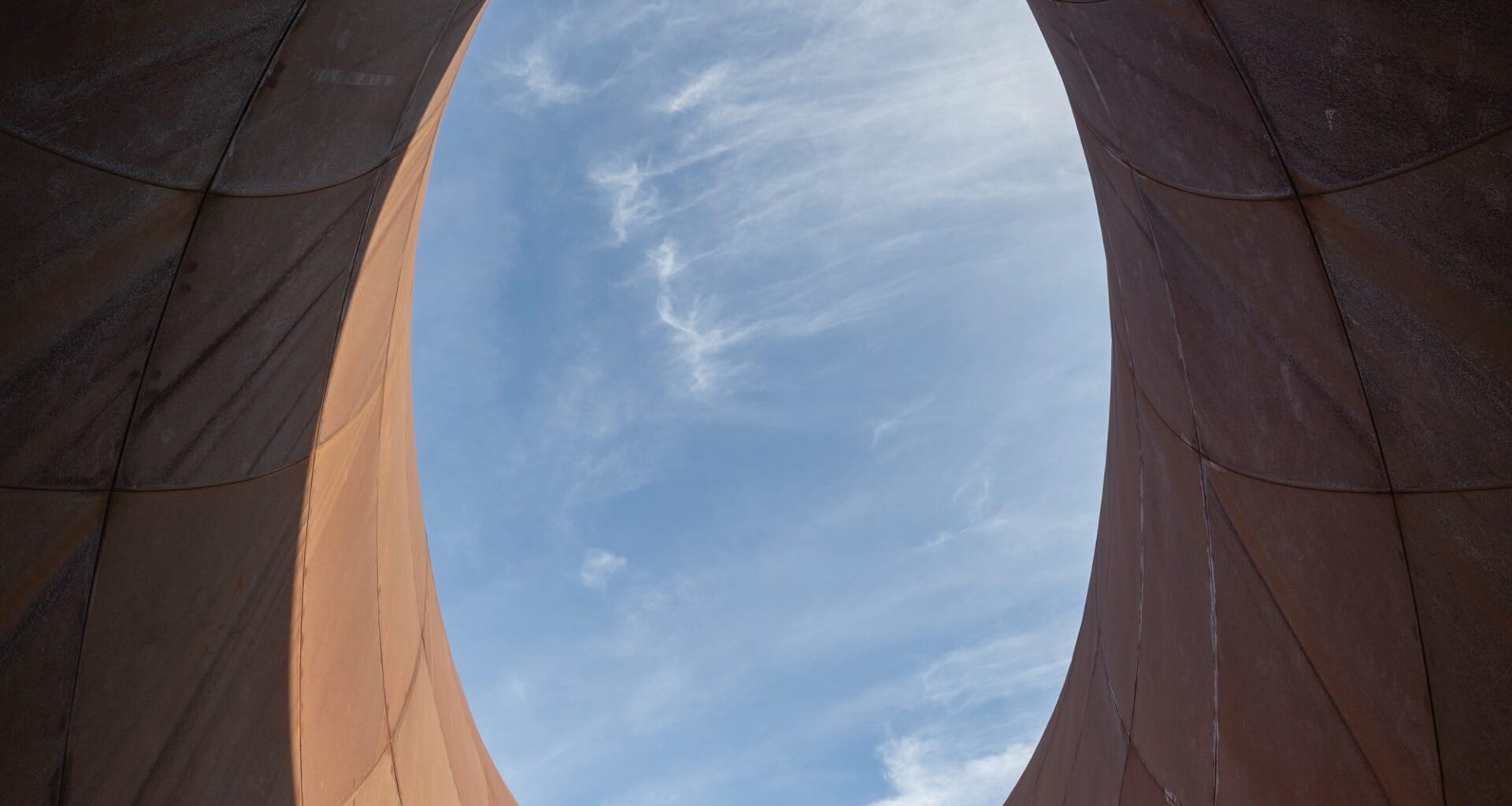 escalators leading up from a contemporary train station in Naples designed by Anish Kapoor