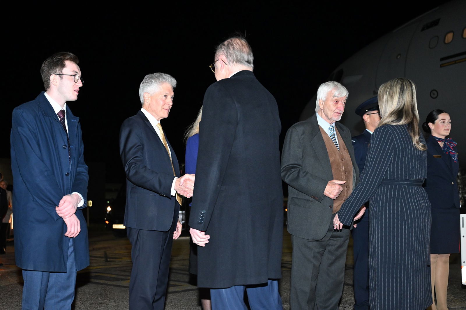 Anthony Albanese is shaking hands with a man on the tarmac in London.