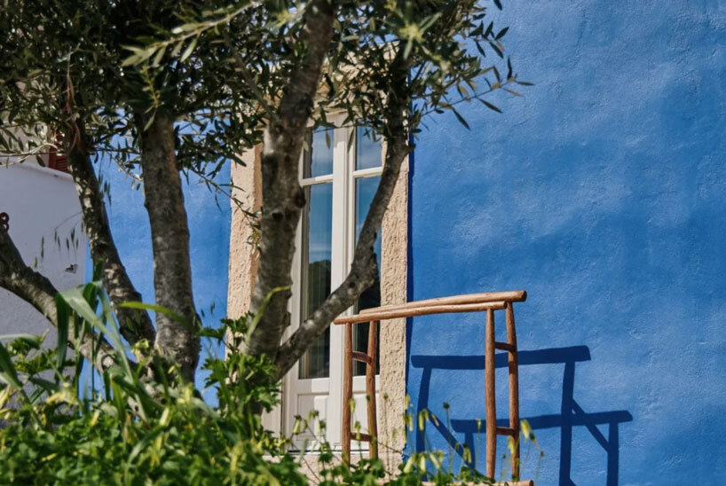 vibrant blue facade brings new life to the monk retreat on leros island, greece