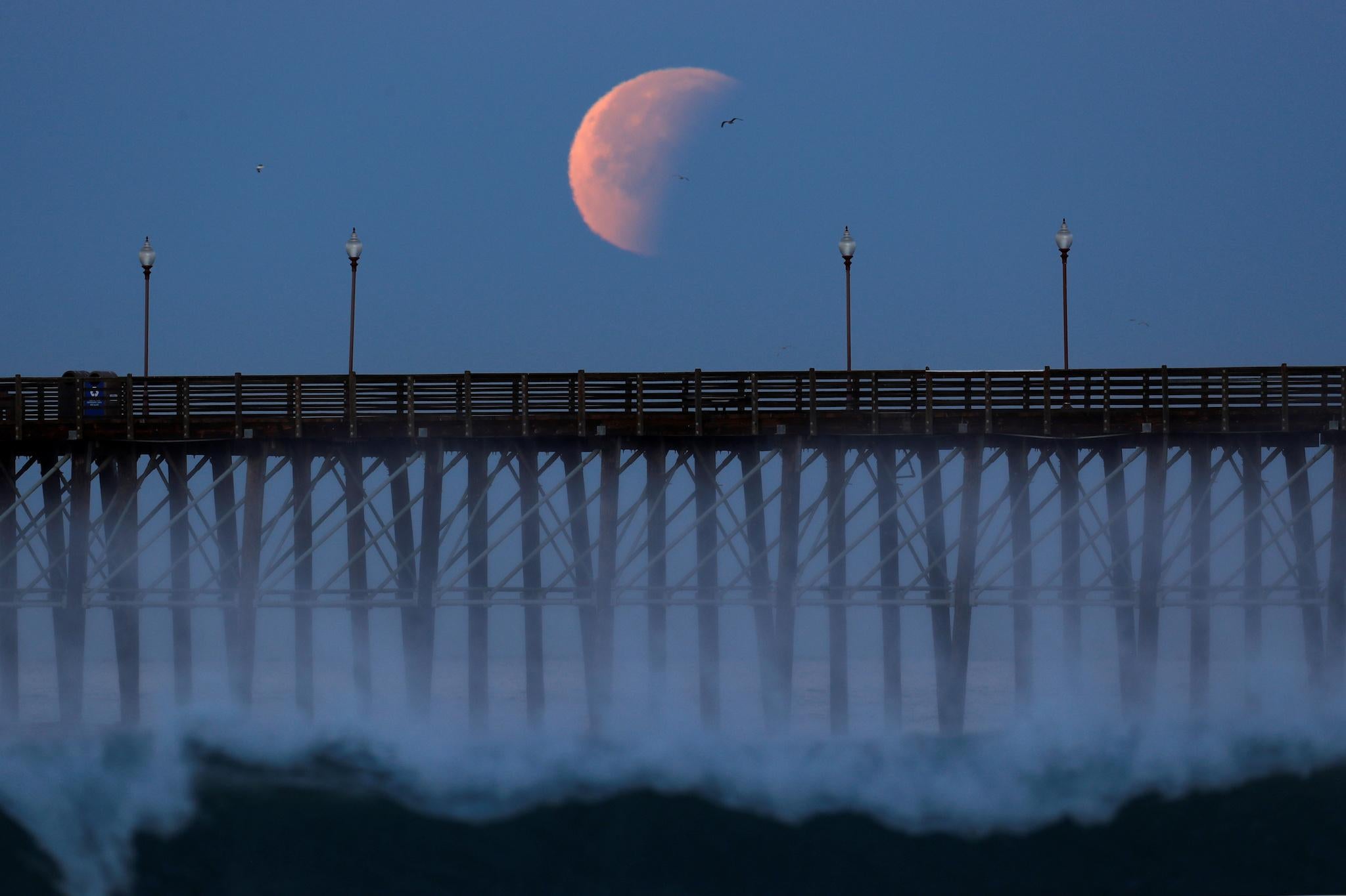 As soon as the moon rises from behind the horizon, it will be darker and redder than usual