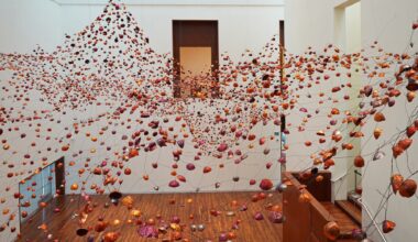 an installation view of a room-size installation by Yasuaki Onishi made of hundreds of copper forms connected by wire