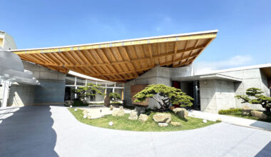 hyperbolic roof composed of curved timber slats covers concrete residence in taiwan