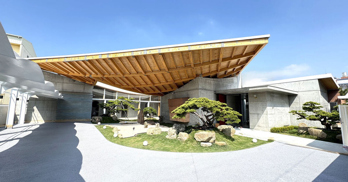 hyperbolic roof composed of curved timber slats covers concrete residence in taiwan