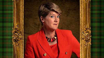 A woman in a red suit looks sideways to camera, her image featured within a gold frame.