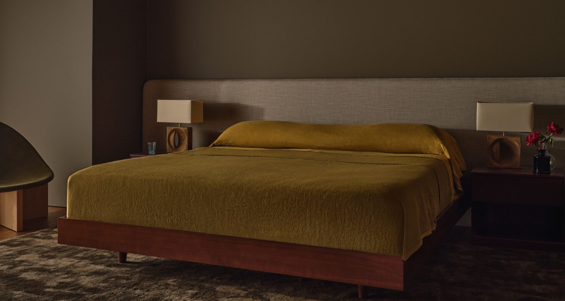 Modern bedroom with dark brown walls.