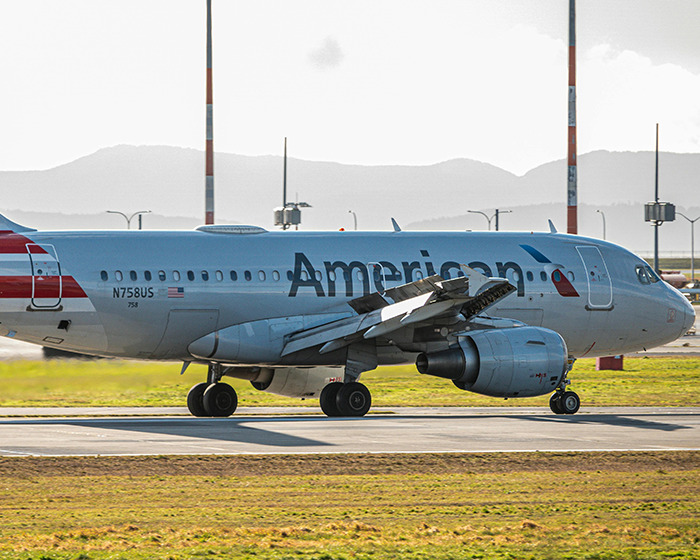 American Airlines plane taxiing on runway, symbolizing entitled passenger incident involving being kicked off flight.