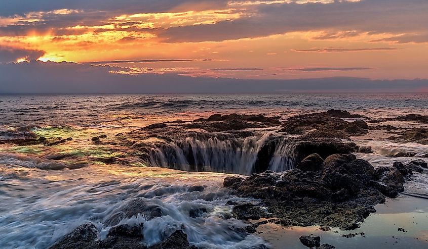 Waves Crashing into Thor's Well, Oregon, Yachats at sunset.