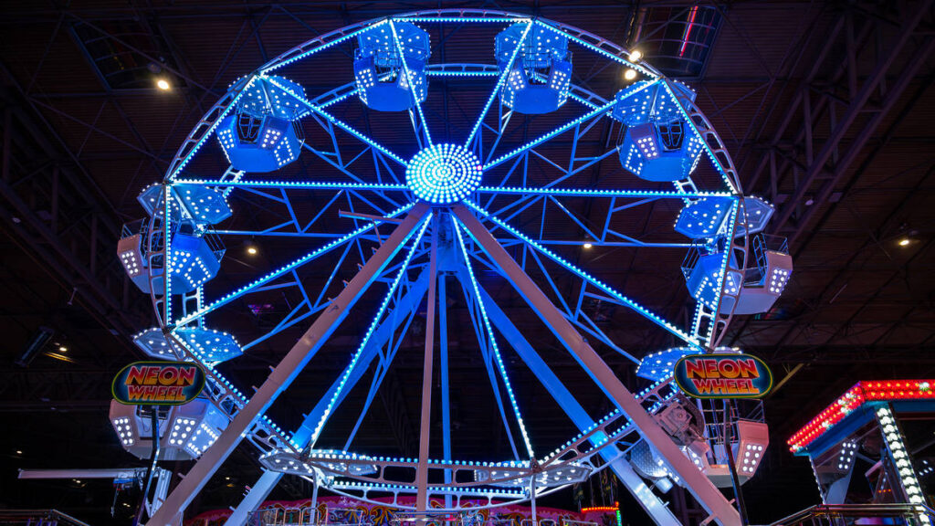 a blue lit up festive ferris wheel