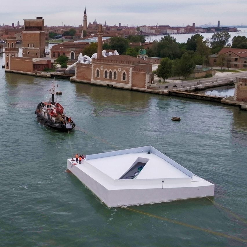 White plaza being towed in Venice