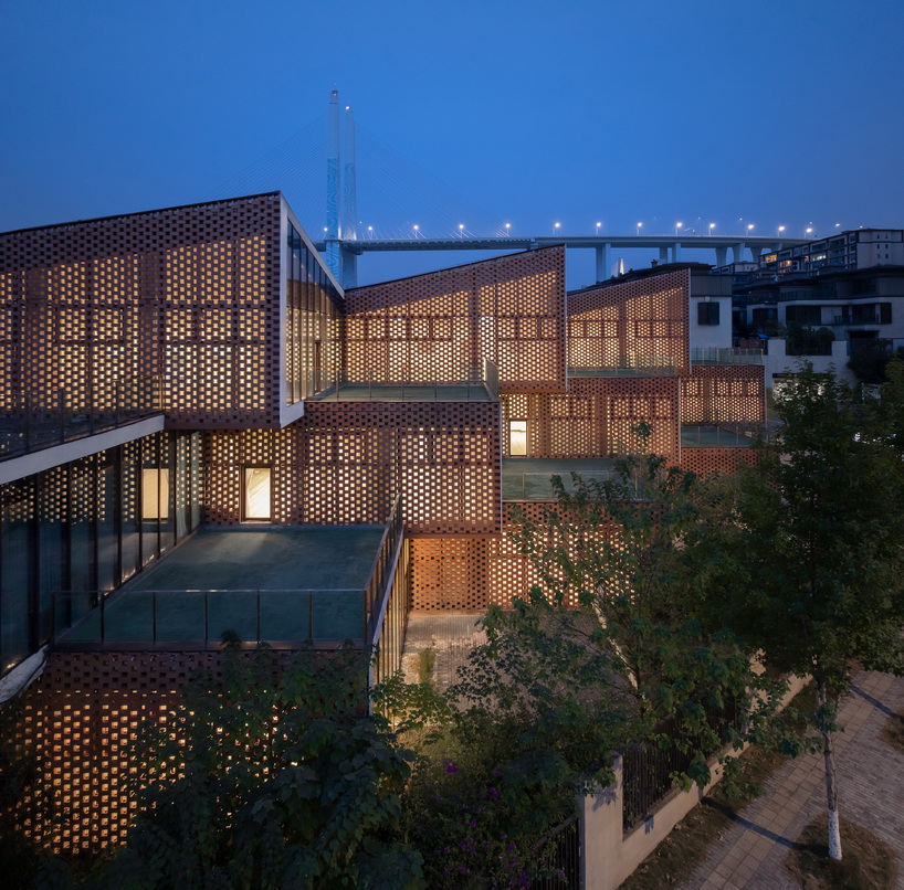 permeable terracotta brick screens wrap kindergarten's stacked volumes by NAN architects