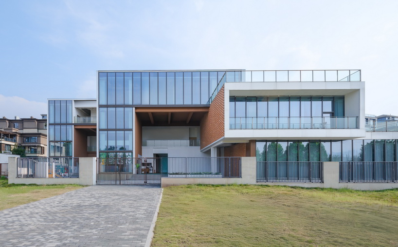 permeable terracotta brick screens wrap kindergarten's stacked volumes by NAN architects