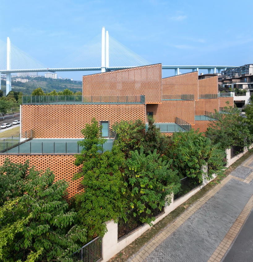 permeable terracotta brick screens wrap kindergarten's stacked volumes by NAN architects