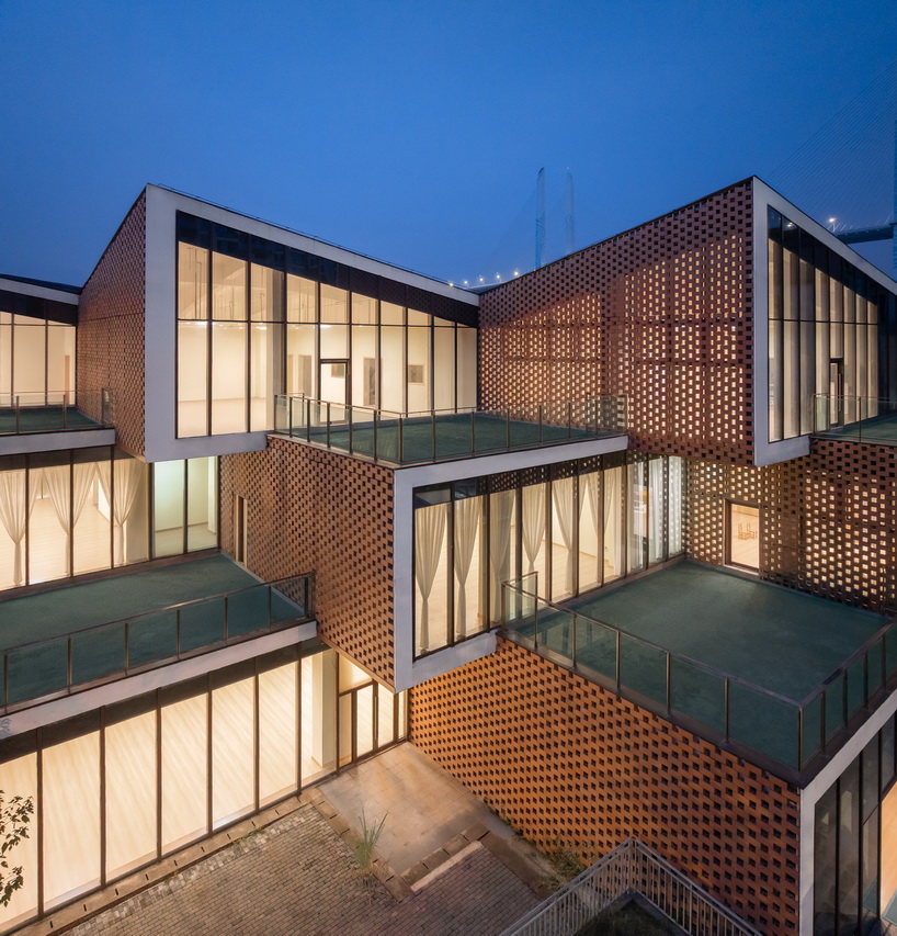 permeable terracotta brick screens wrap kindergarten's stacked volumes by NAN architects