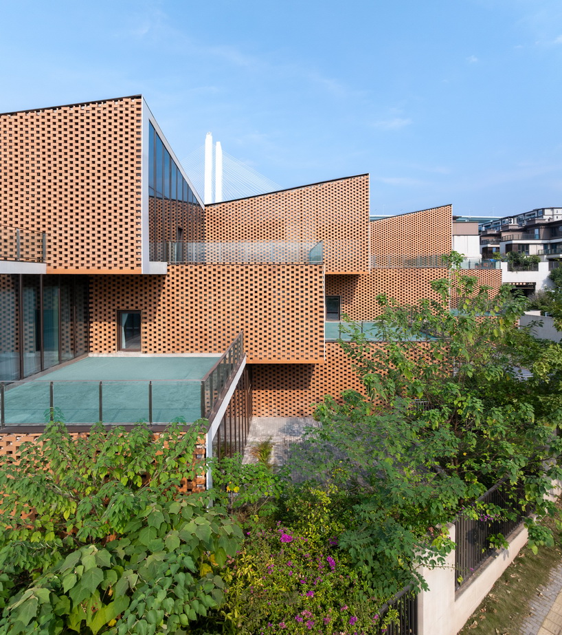 permeable terracotta brick screens wrap kindergarten's stacked volumes by NAN architects