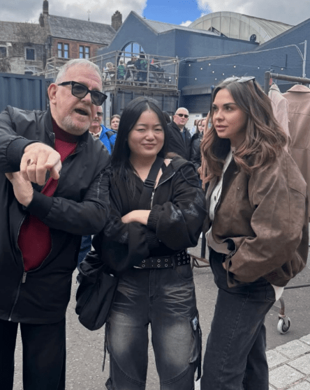 Three people posing for a photo outdoors.