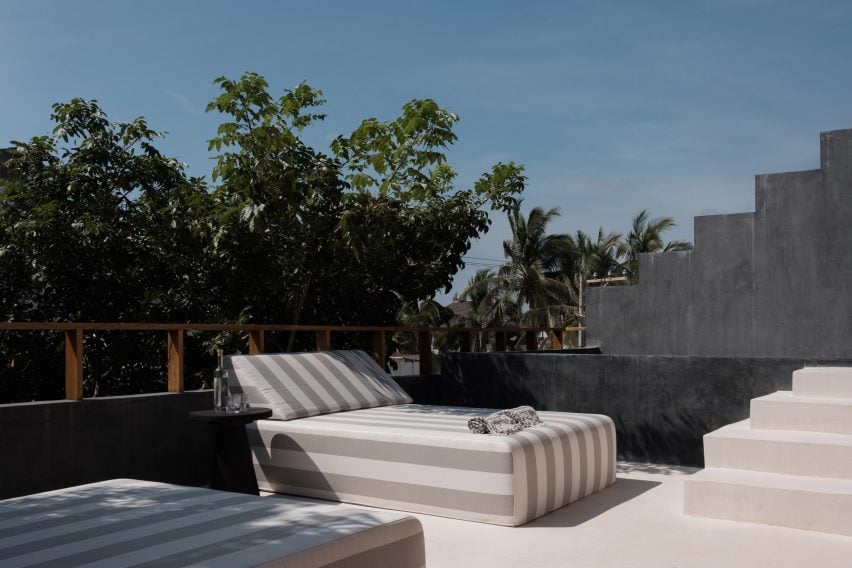 Comfy loungers set against dark grey chukum walls