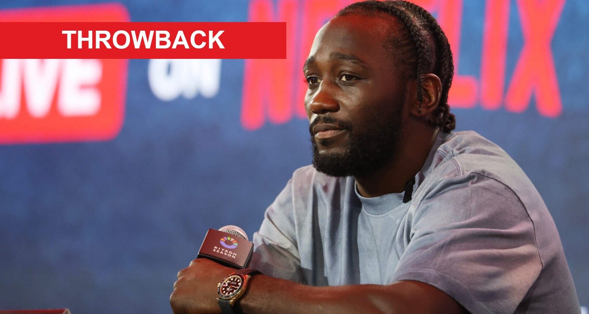 Terence Crawford on stage at a press conference at Fanatics Fest, inset throwback banner
