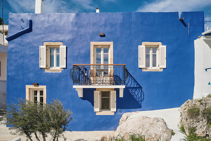 vibrant blue facade brings new life to the monk retreat on leros island, greece