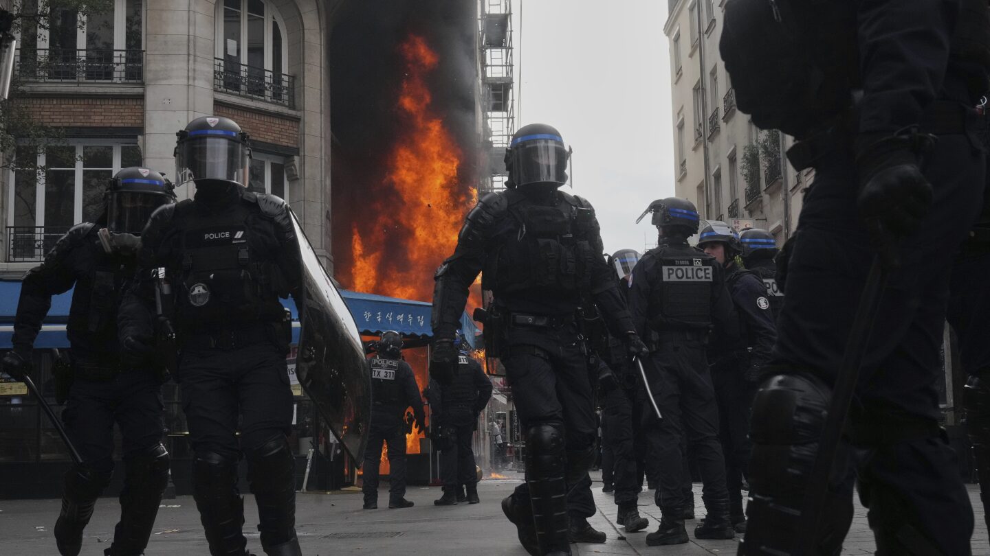 Protesters block roads and set blazes in France amid police tear gas