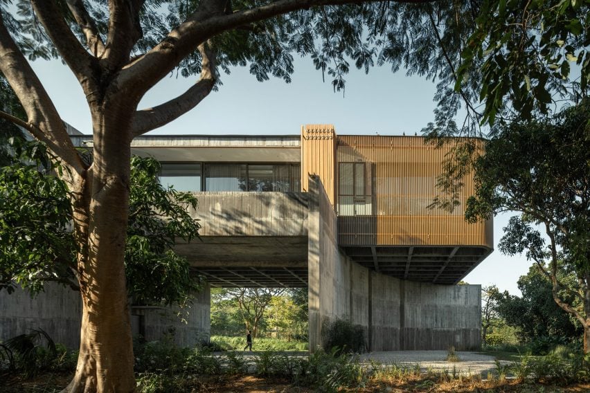 View from garden of concrete home by IDIN Architects
