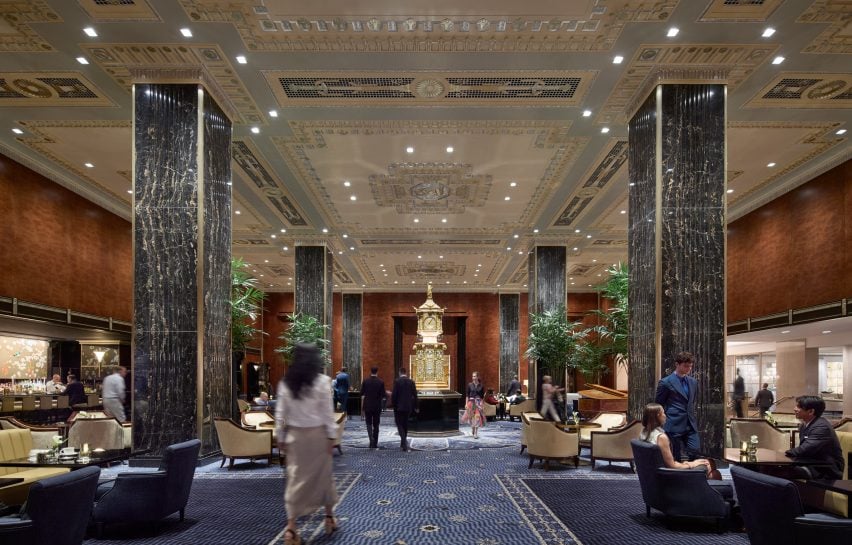Hotel lobby with large columns and wood panelling