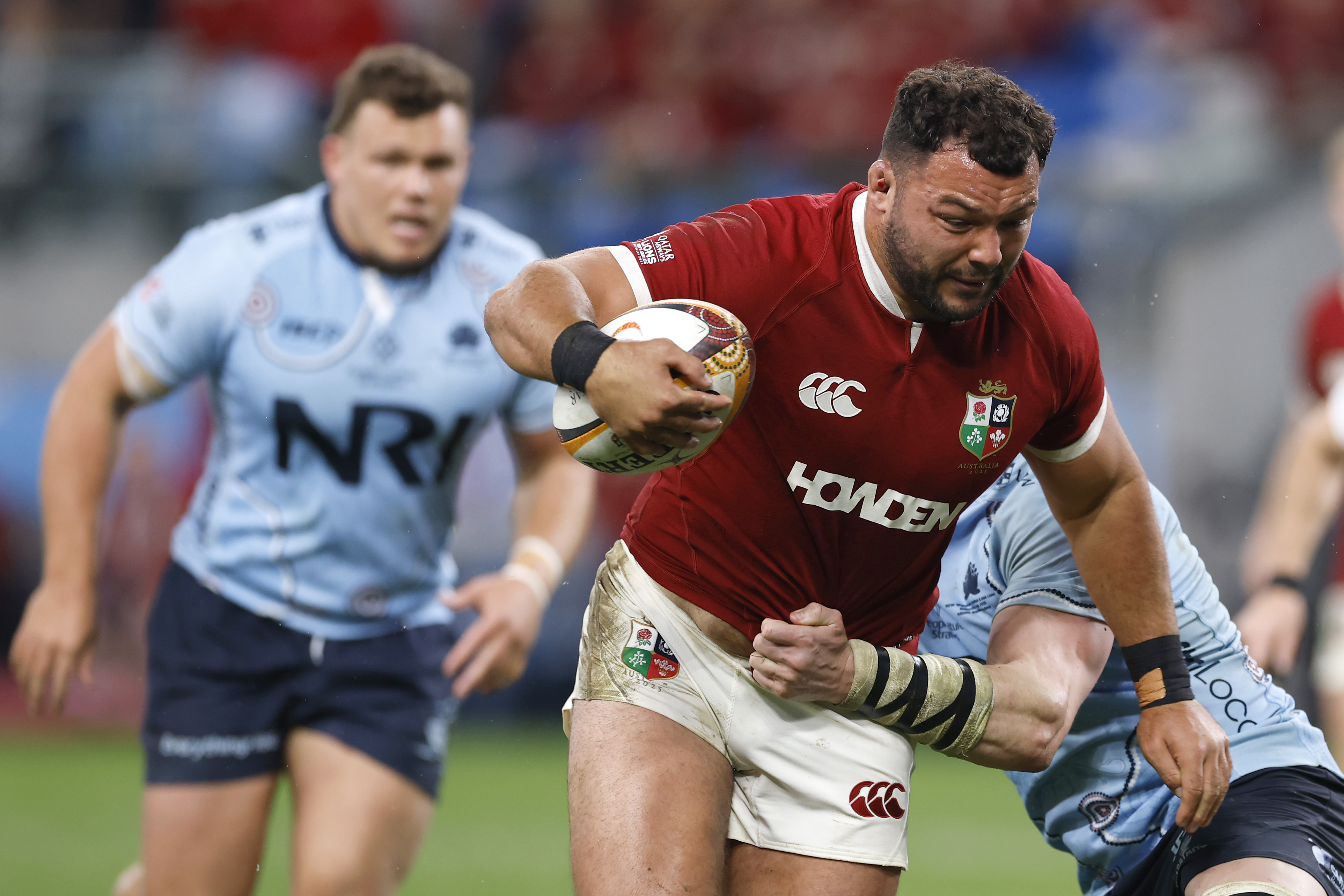 Ellis Genge of the British and Irish Lions rugby team being tackled during a match against NSW Waratahs.