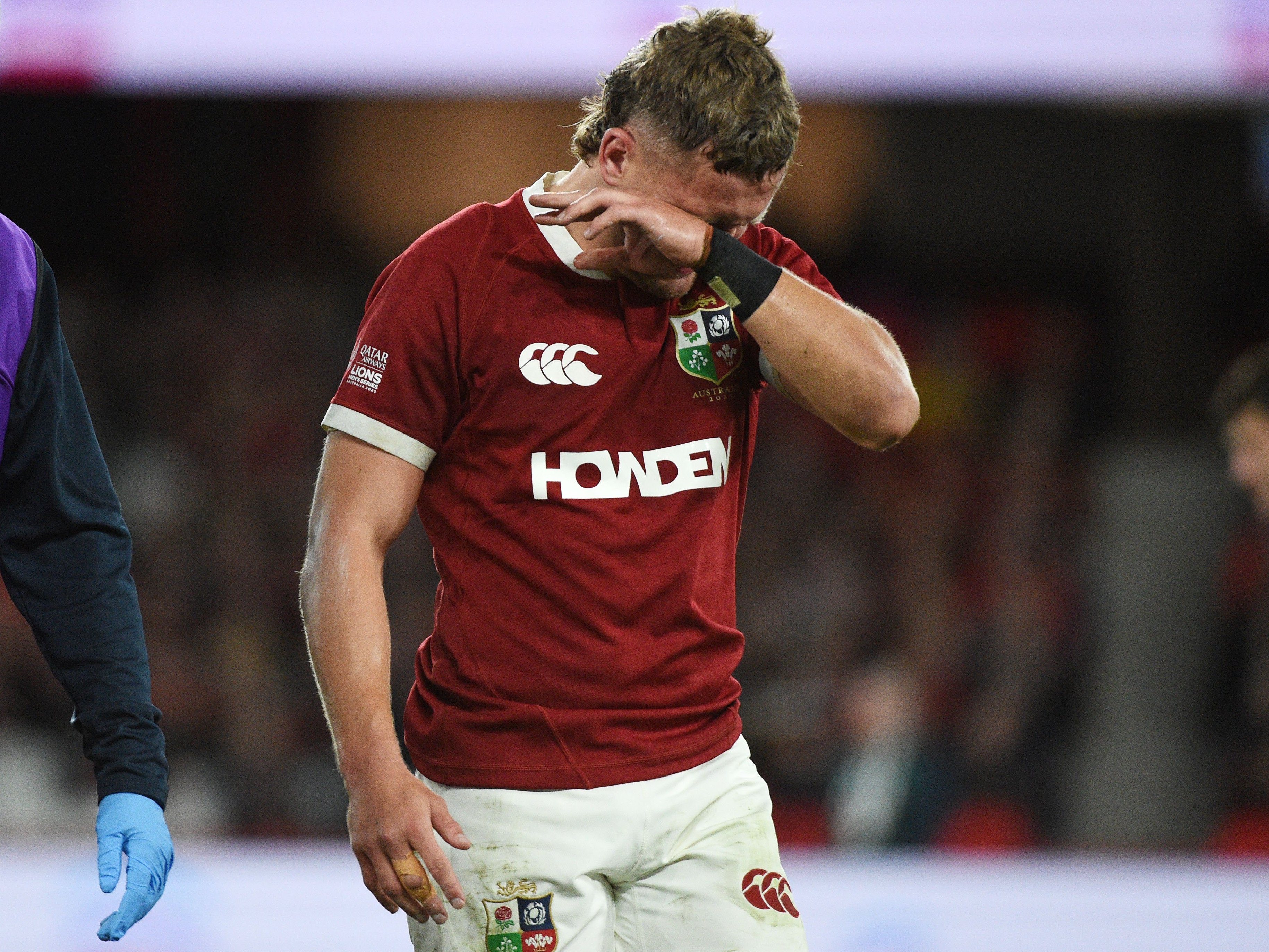 Darcy Graham, British & Irish Lions winger, distraught after injuring his left leg and being consoled by team doctor Geoff Davies.