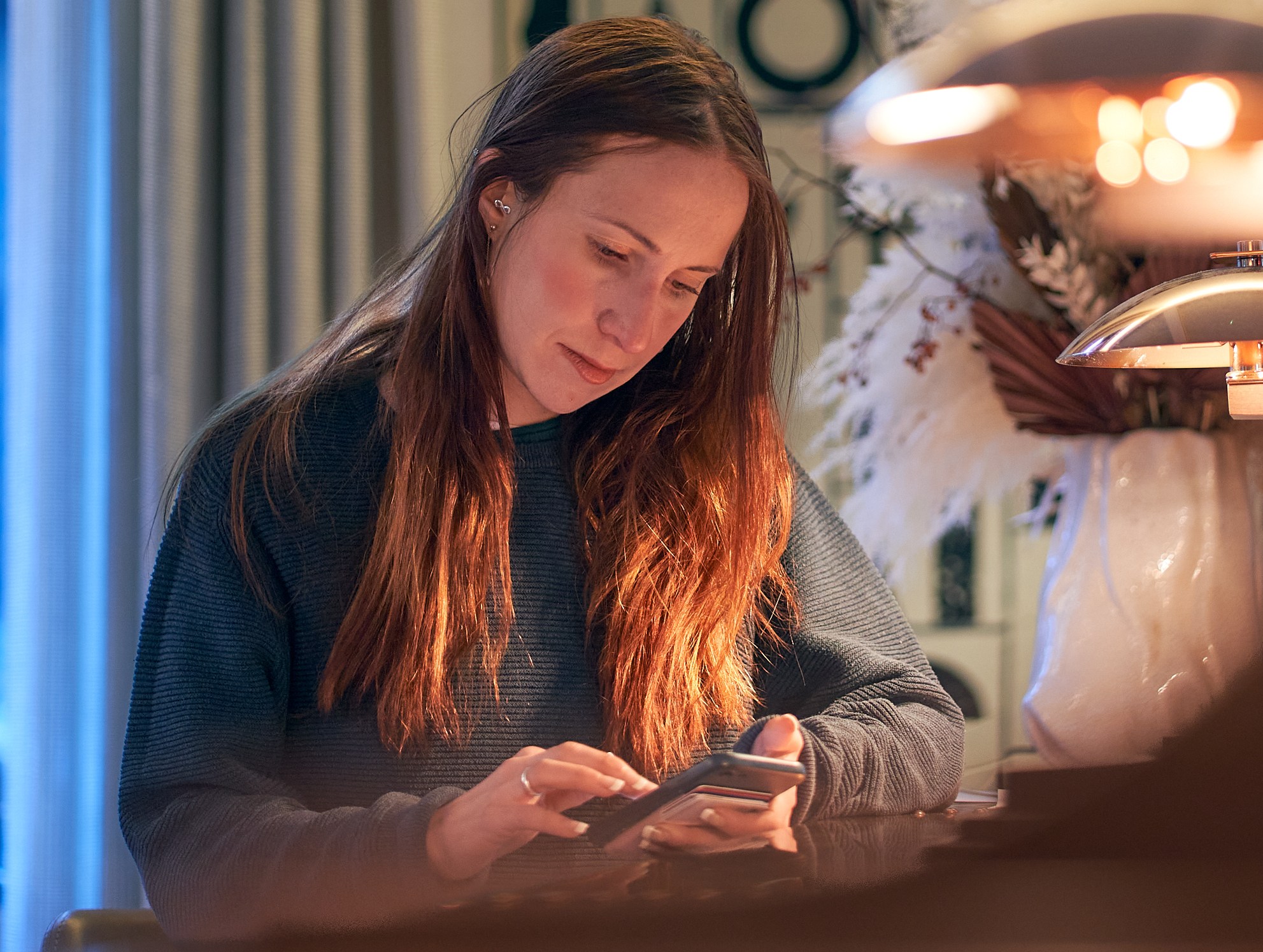 Francesca Booker-Brown, 38, from Ashford, using a smartphone.