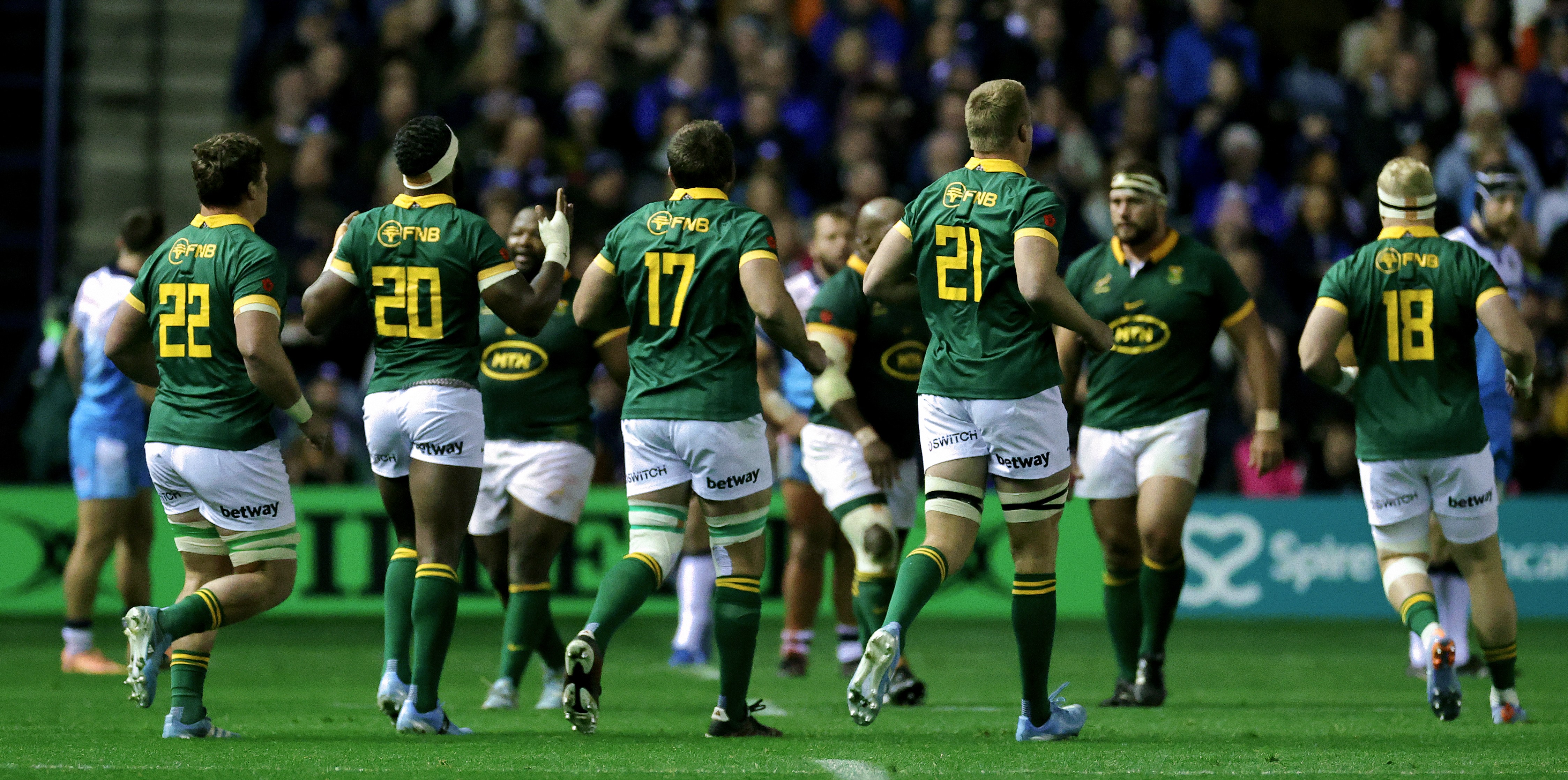 South Africa rugby players, including Siya Kolisi, Pieter-Steph du Toit, Jasper Wiese, Gerhard Steenekamp, Malcolm Marx, and Vincent Koch, walk onto the field as substitutes.