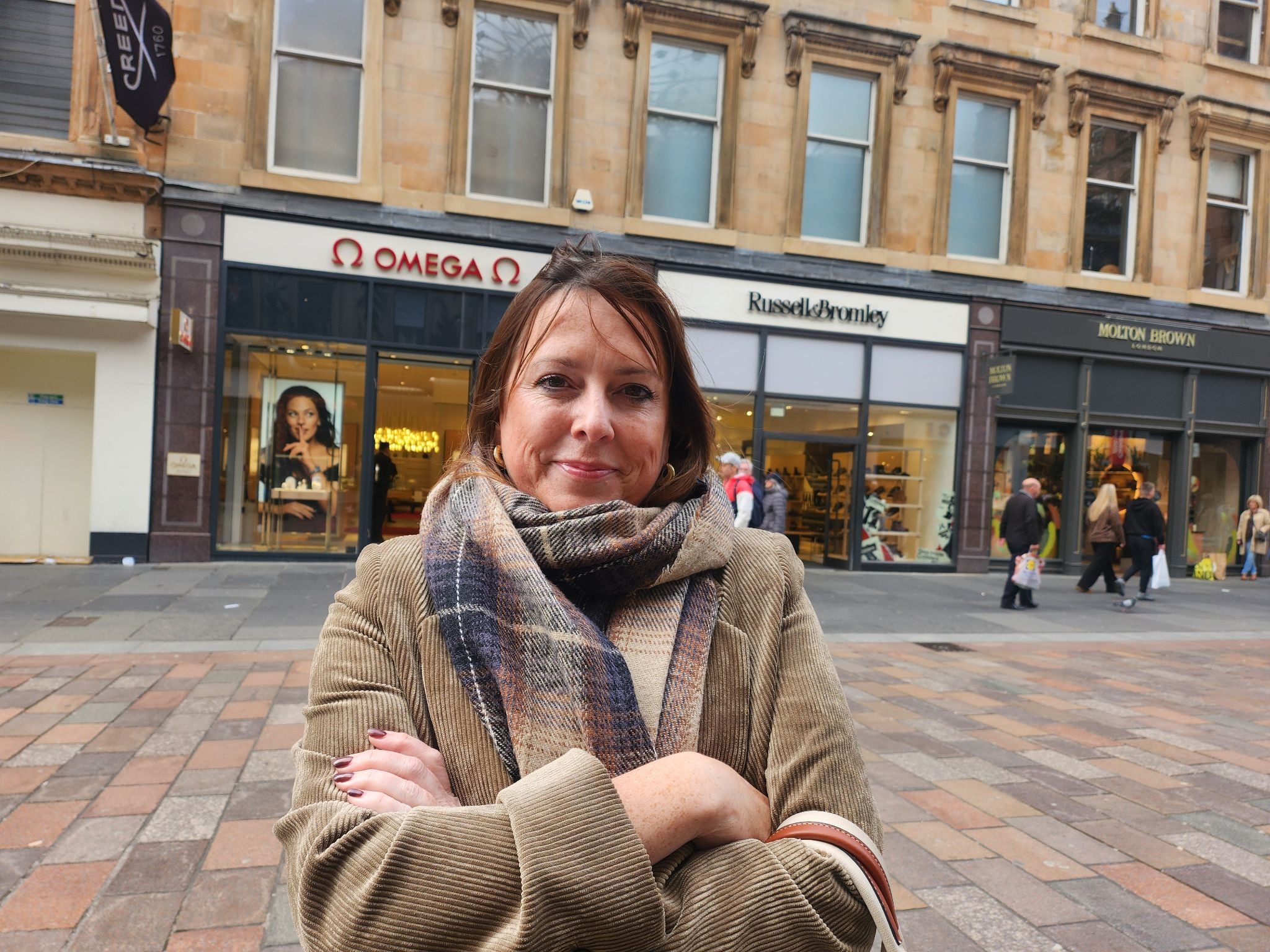 Nicola Broadfoot posing outside of an Omega store.