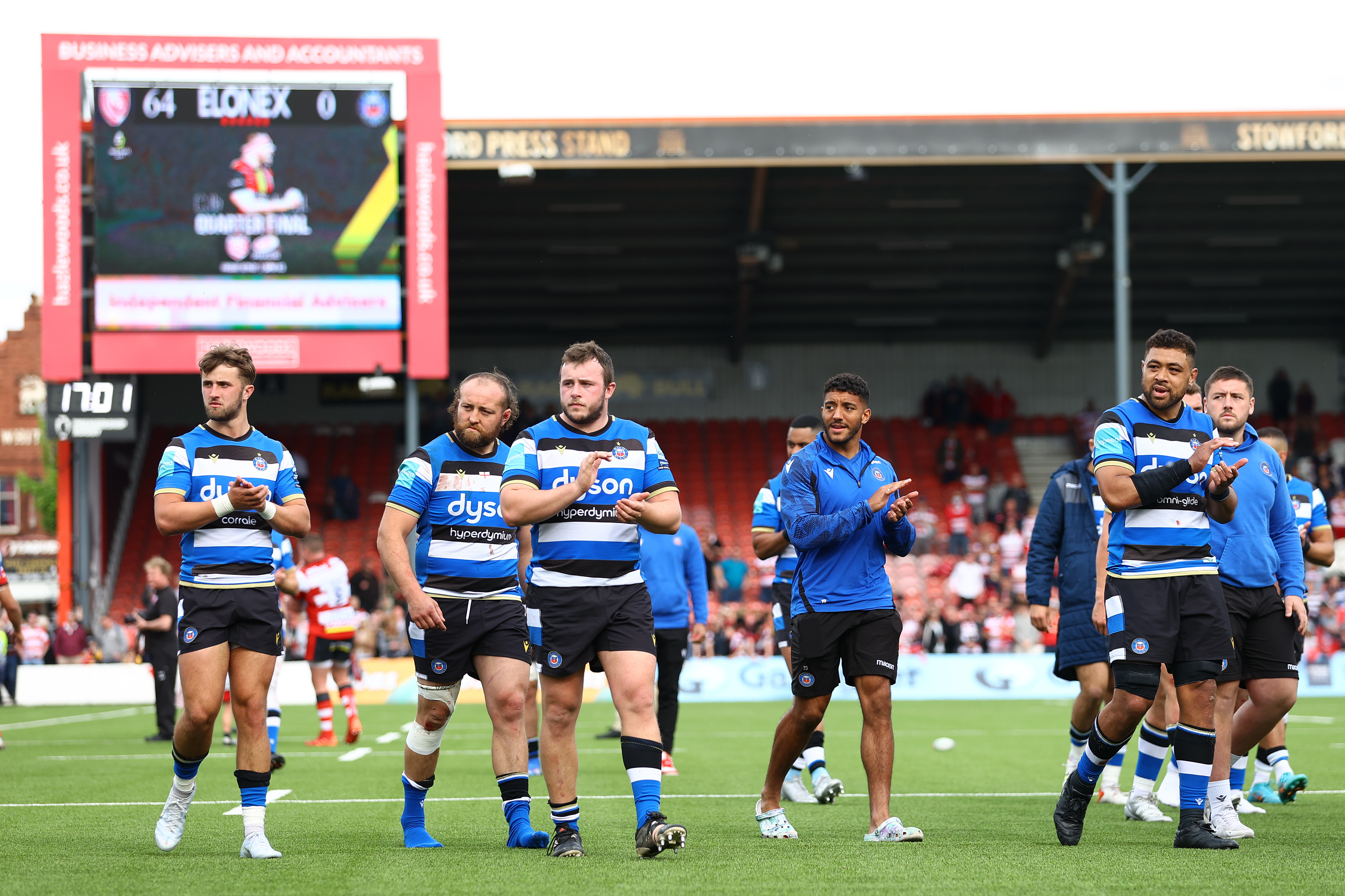Bath rugby players react to their 0-64 defeat against Gloucester.