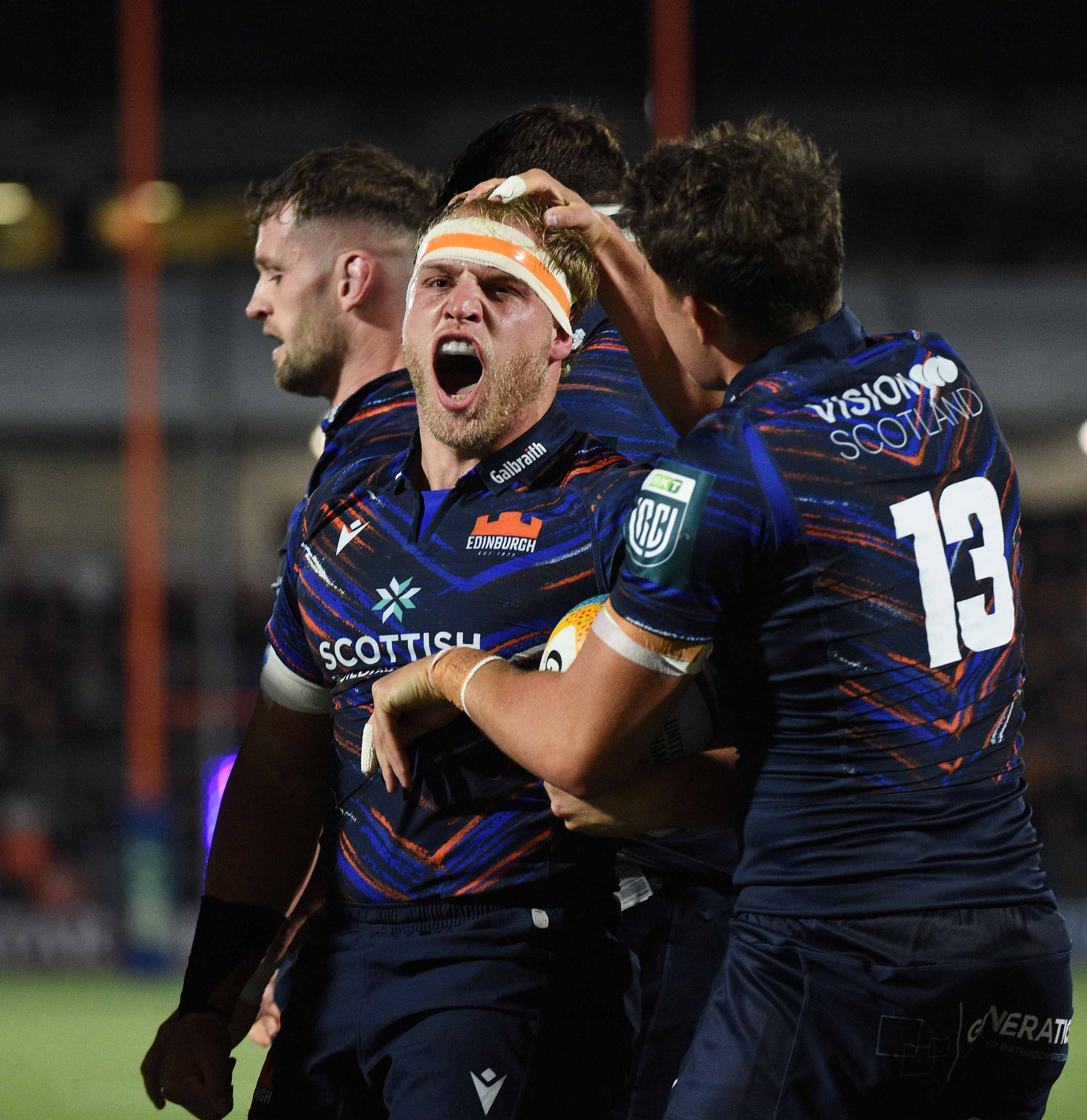 Dylan Richardson, Edinburgh flanker, celebrates scoring a try.