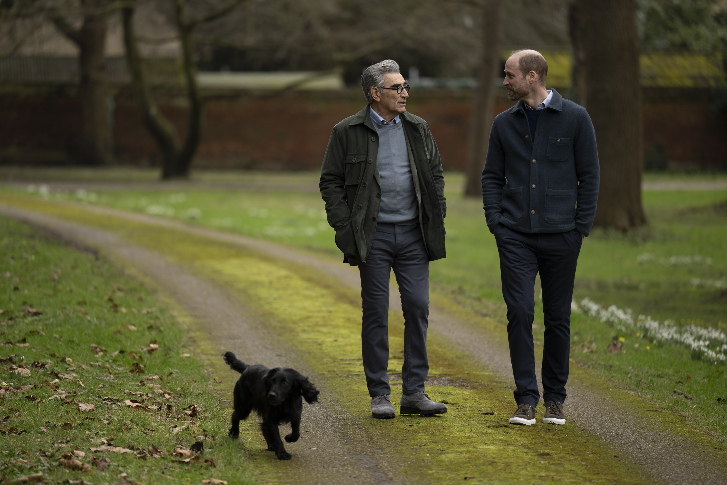 Eugene Levy and Prince William walking a dog at Windsor Castle.