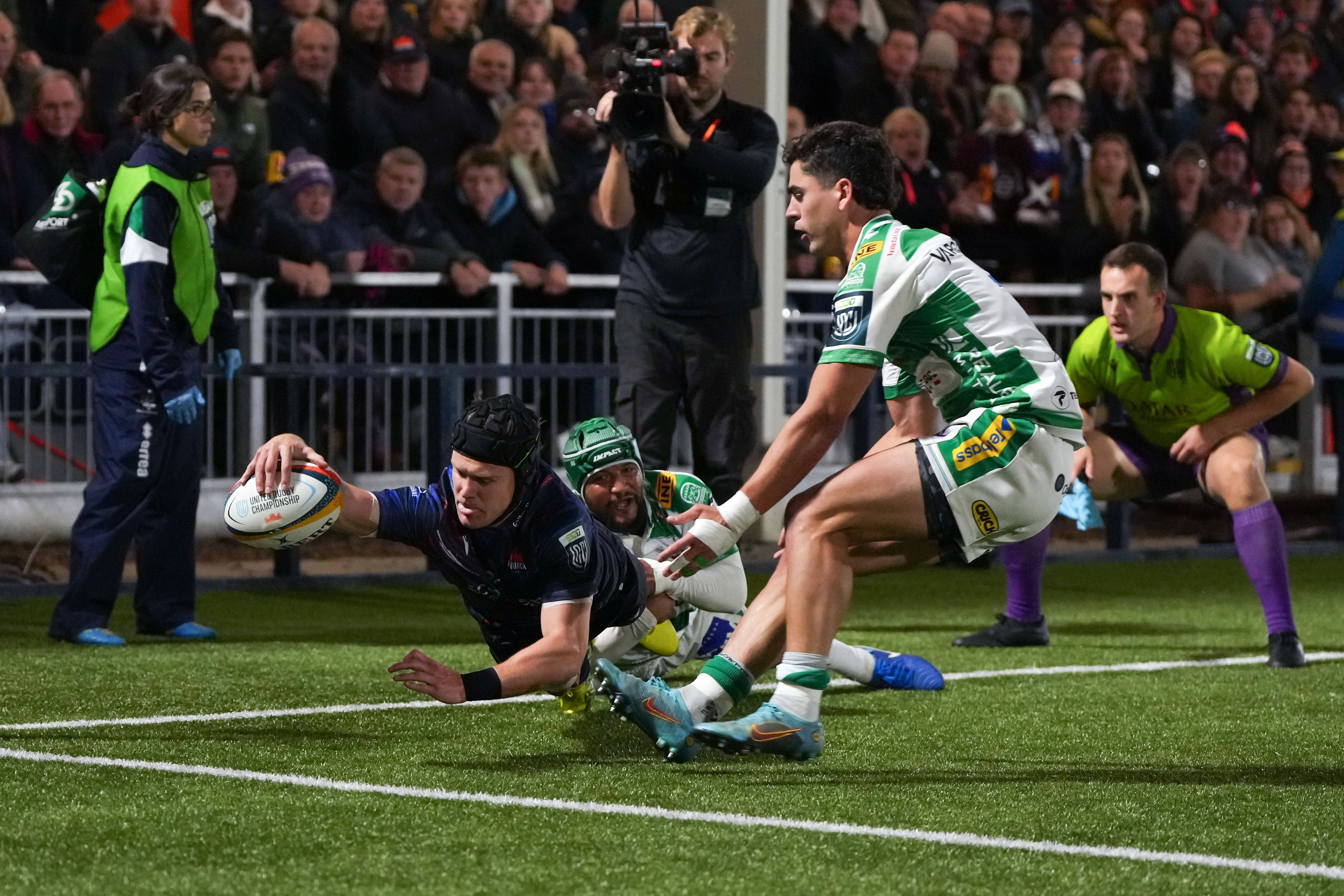 Darcy Graham of Edinburgh scoring a try for his team during a rugby match.