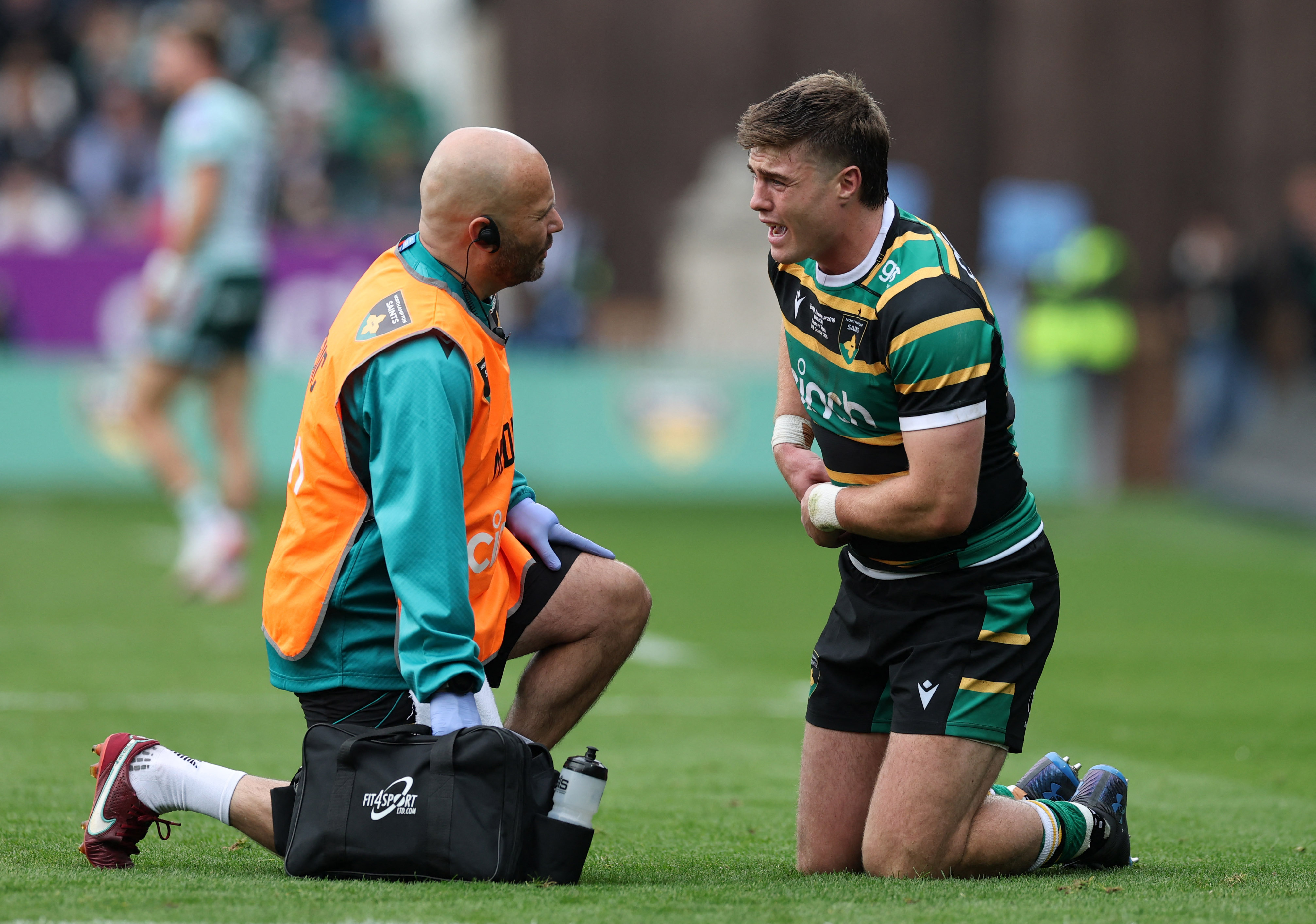 Northampton Saints player Tommy Freeman receives medical attention for an injury during a match against Leicester Tigers.