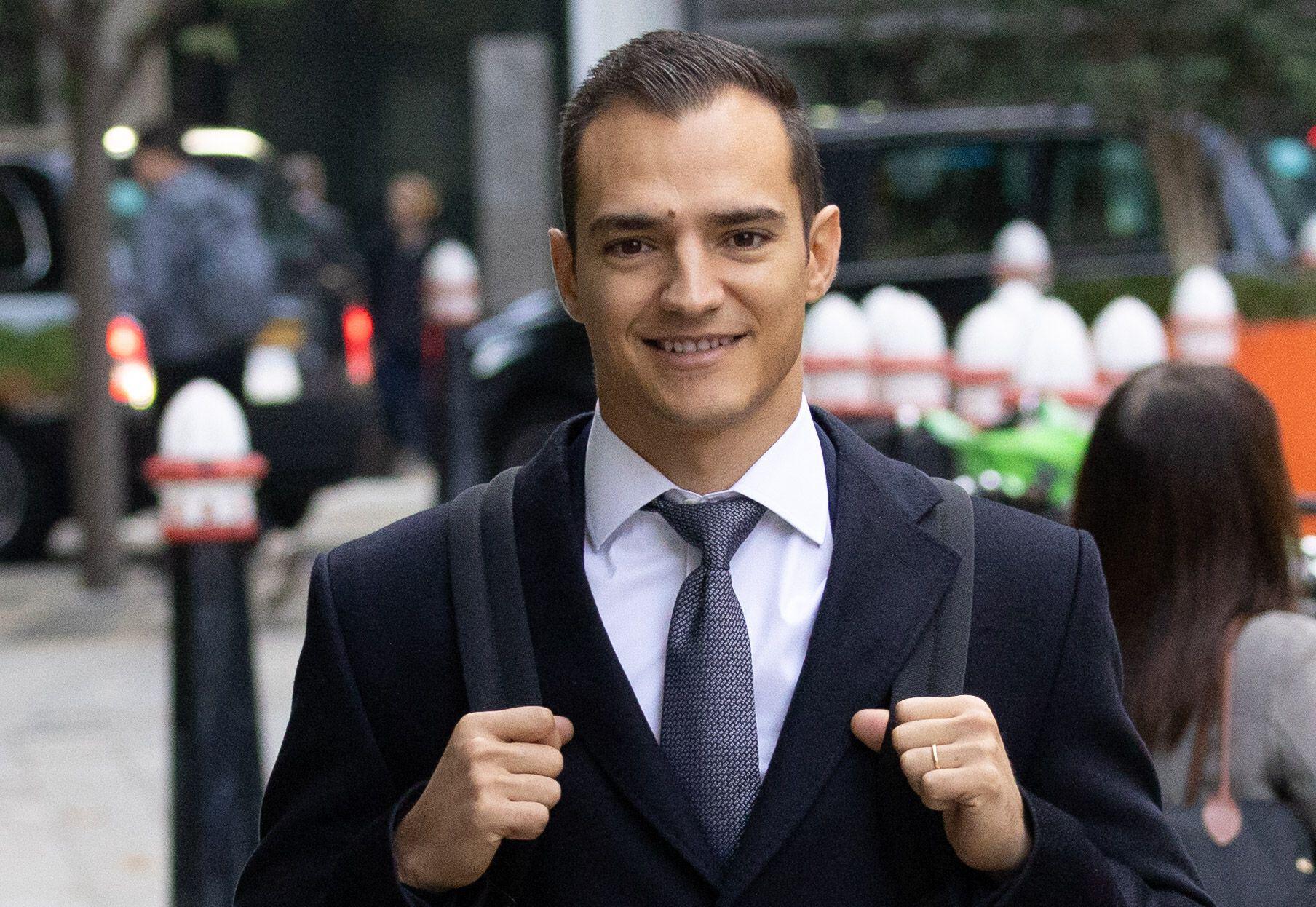 Spanish racing driver Alex Palou smiling while arriving at Rolls Building for a legal claim.