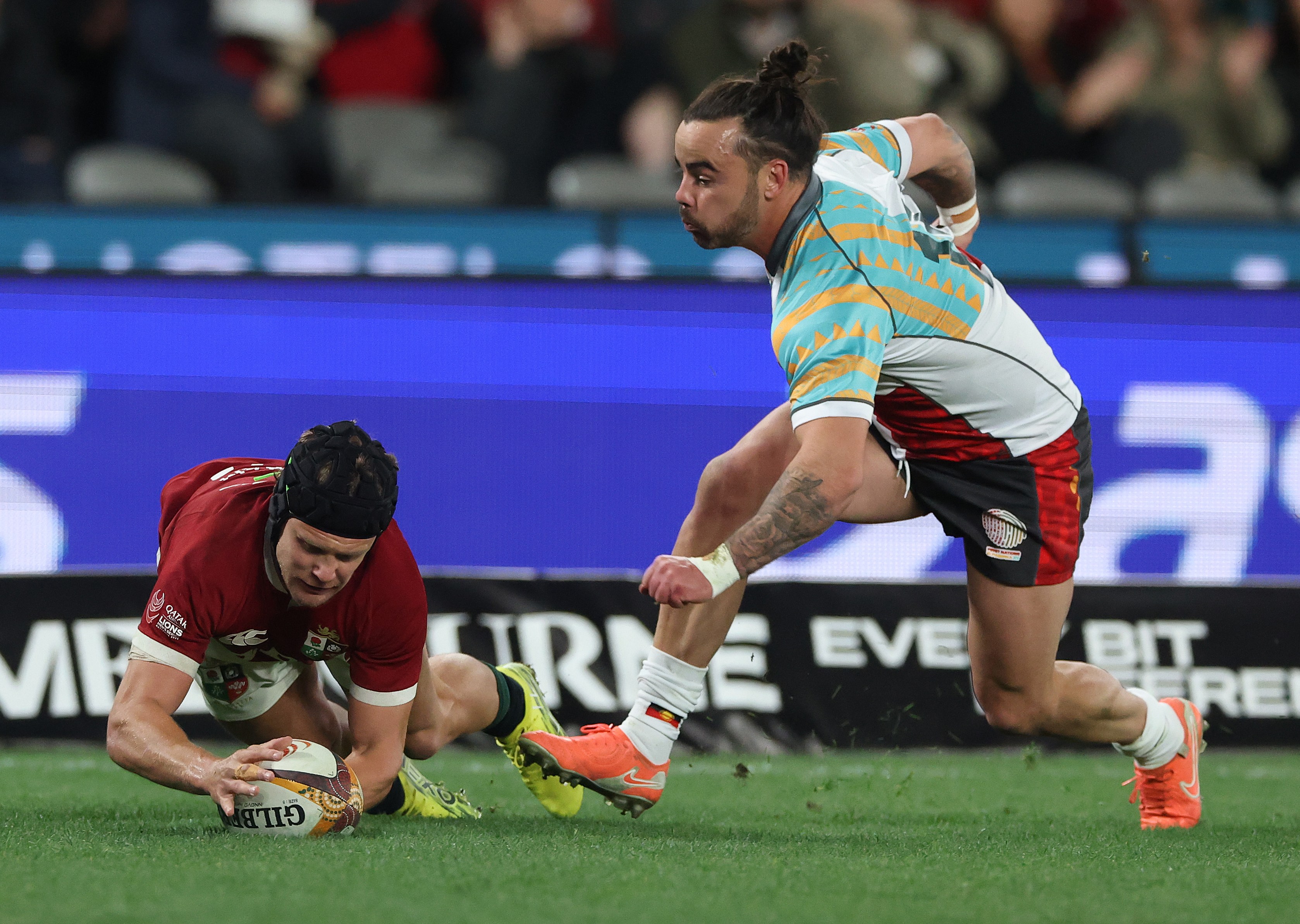 Darcy Graham of the British & Irish Lions scores their second try against the First Nations & Pasifika.
