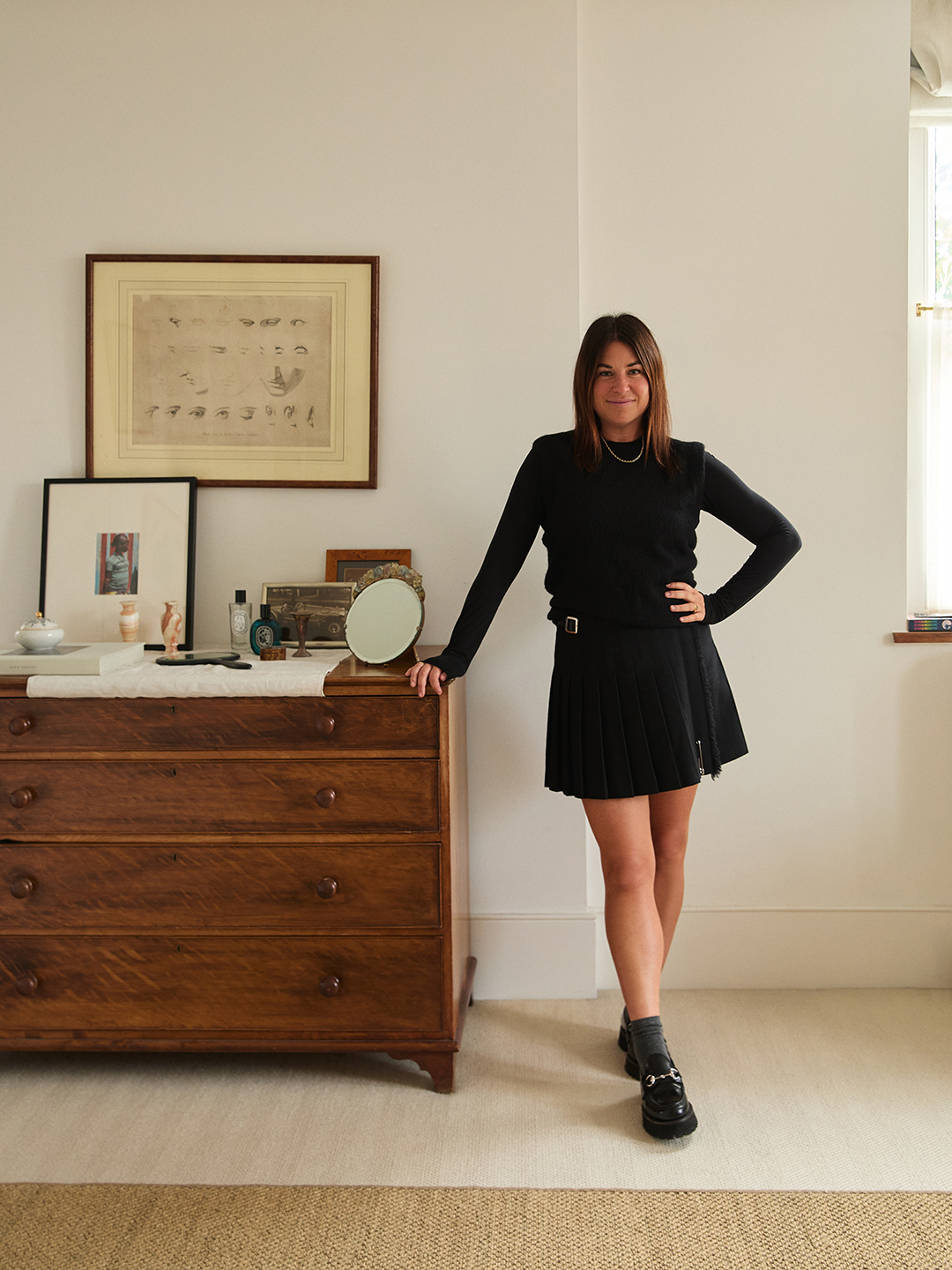 woman leaning on drawers