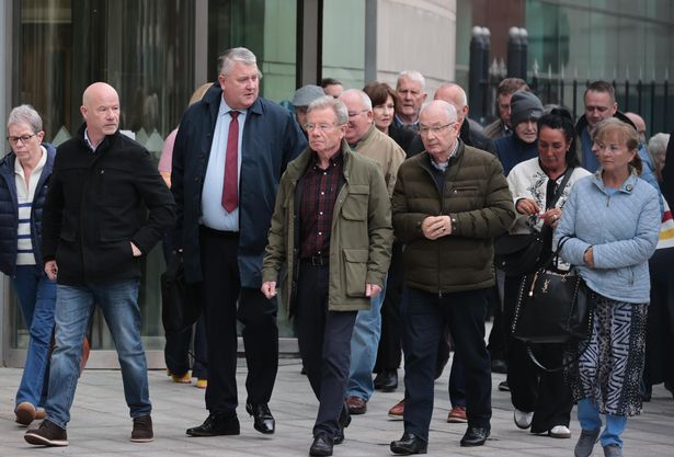 Solicitor Fearghal Shiels (second left)  with the brothers of victim William McKinney - John McKinney (left) , Joe McKinney (centre), and Mickey McKinney (second right) - and supporters outside Belfast Crown Court