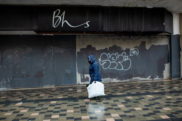 A shoppers passes the closed British Home Stores (BHS) department store on Sauchiehall Street in Glasgow